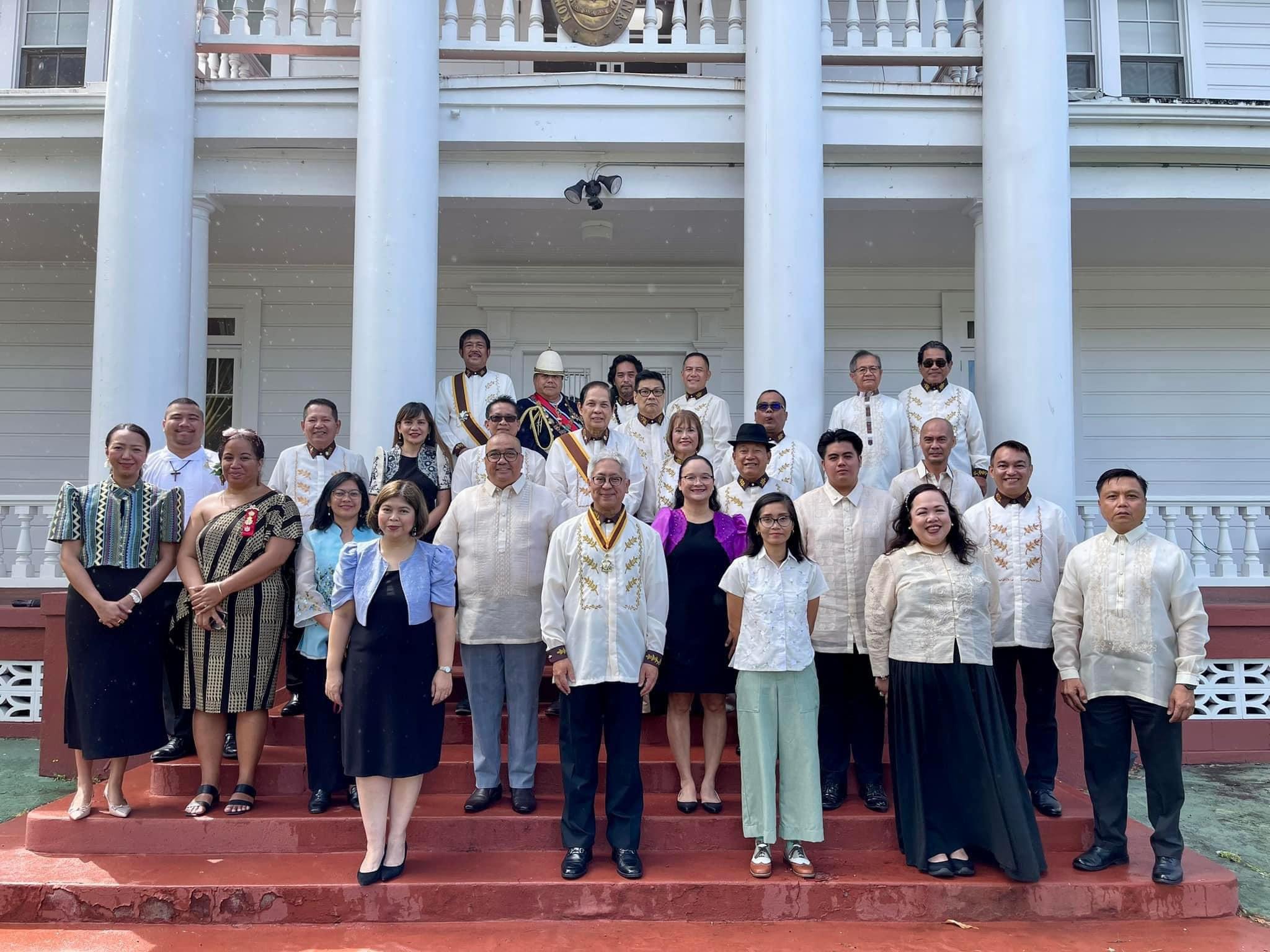 A group of people in traditional Filipino attire gathered on the steps of a building to celebrate Jose Rizal and pay tribute to Rizal’s legacy.